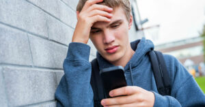 teen-boy-upset-smartphone